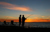 Beach fishing at sunset